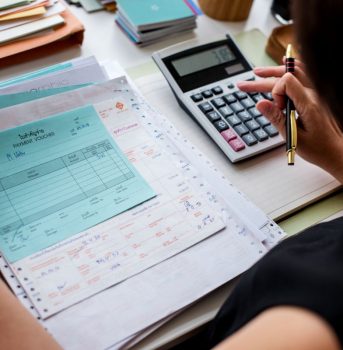 Asian woman working through paperwork